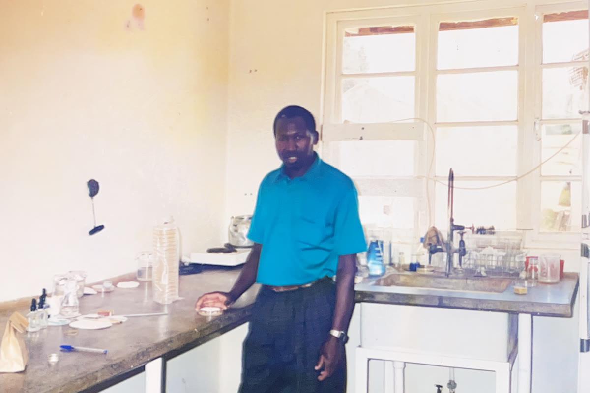 Andrew standing in a laboratory beside a workbench and sink.